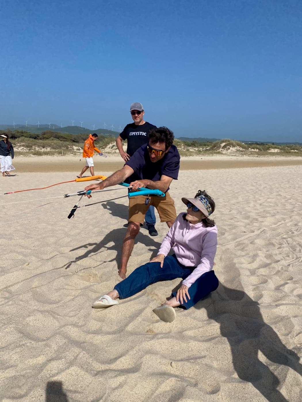 A participant practicing kite bar trimming with an instructor